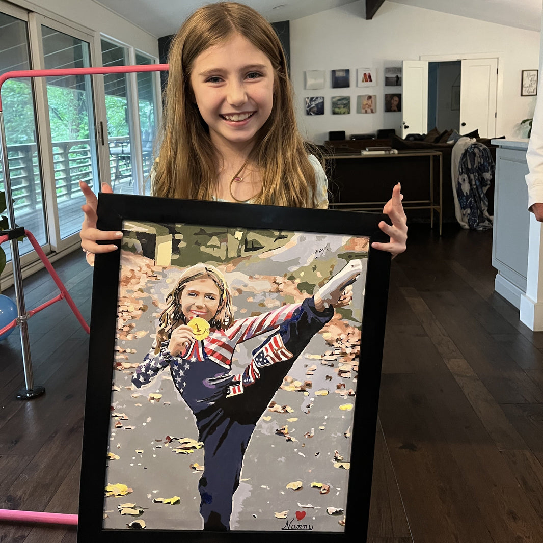 Girl holding a finished custom paint by numbers portrait made from her photo, a personalized gift idea for girls.