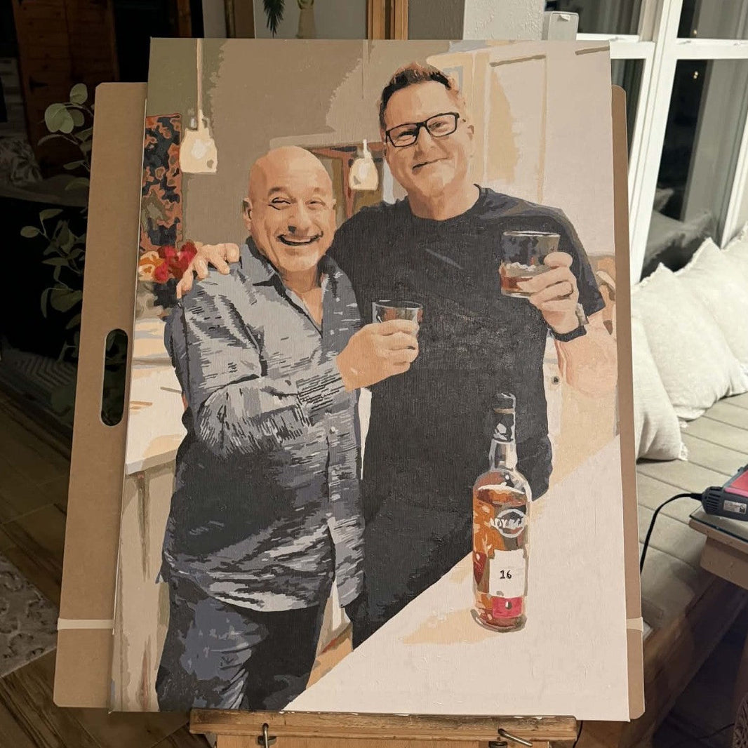 A photo of a father with his child beside the numbered paint by numbers canvas made from it, as a Father's Day gift.