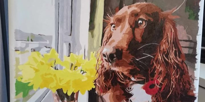 A finished pet memorial canvas painted by numbers from a photo of a dog, framed and hung on a wall.