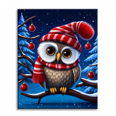 A paint by numbers canvas of an owl wearing a red striped hat and scarf, perched on a snowy branch with red baubles and pine trees at night.