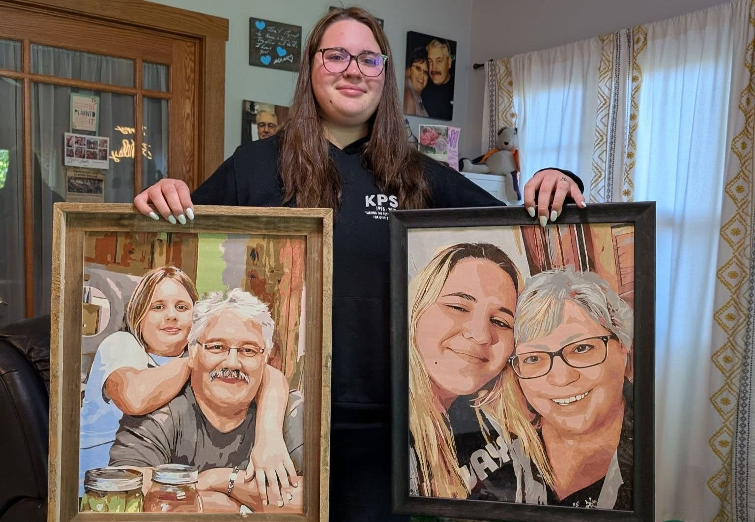 Customer holding framed custom paint by number portraits created from personal family photos