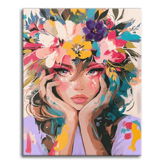 A colorful modern portrait of a young woman resting her chin in her hands, crowned with bright flowers in a fashion-illustration style, shown as a paint by numbers canvas.