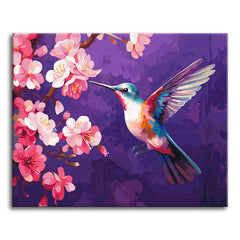 A colorful hummingbird hovering beside a branch of pink cherry blossoms against a deep purple background, shown as a paint by numbers canvas.