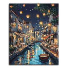 A paint by numbers canvas of a canal at night lit by hanging lanterns, with waterside café tables, moored boats, and warm reflections on the water.