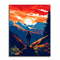A mountain paint by numbers design showing a hiker standing on a rocky summit against a red and orange sunset sky with layered blue peaks.