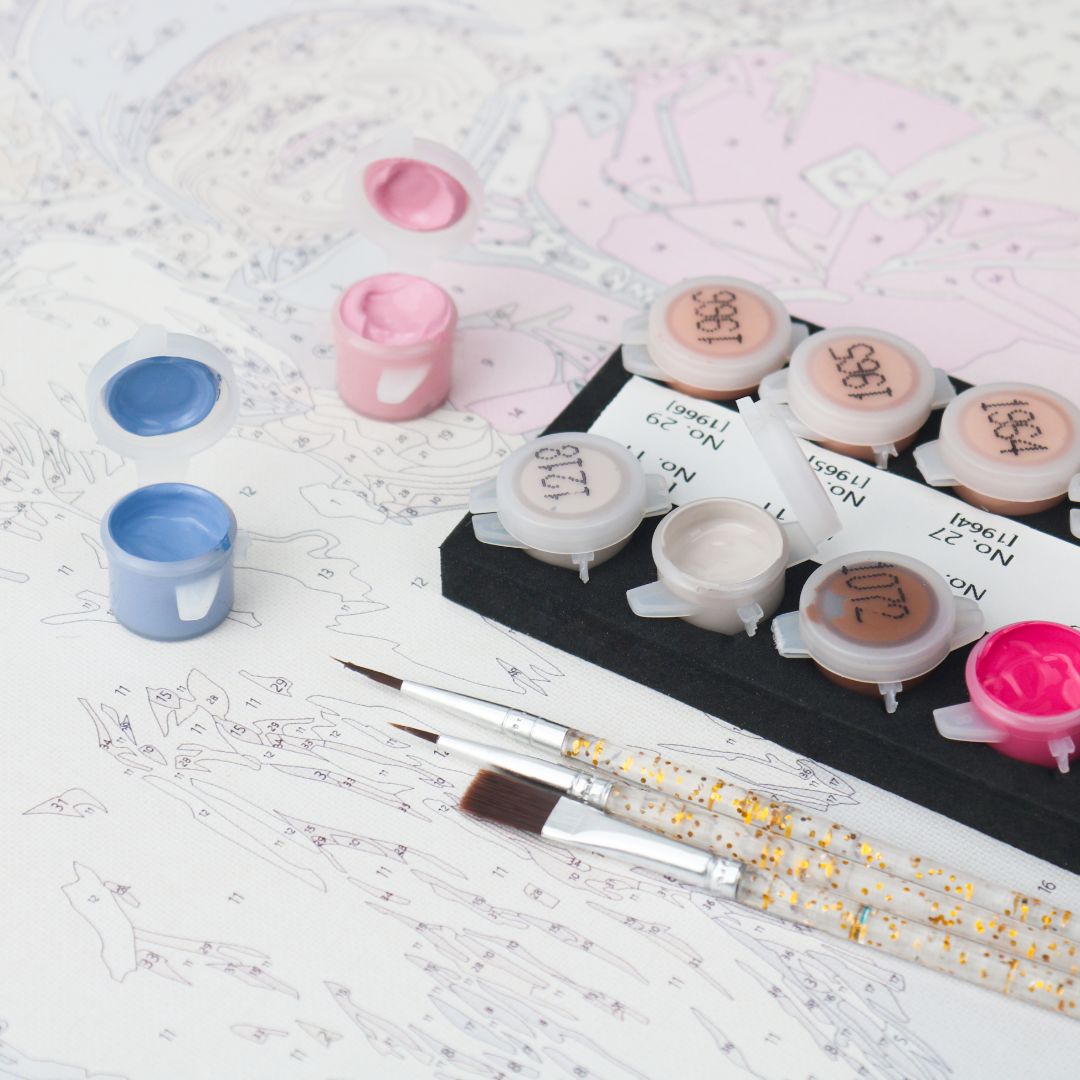 Paint by numbers paint pots, brushes and numbered canvas ready for painting
