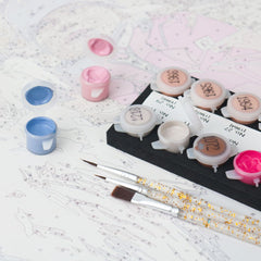 Paint by numbers paint pots, brushes and numbered canvas ready for painting