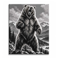 A bear standing upright on a rocky ledge with its mouth open and claws raised, with snowy peaks, pines, and a river valley behind, in a black and white paint by numbers design.