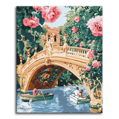 A paint by numbers canvas of an ornate stone bridge over calm water, framed by large pink roses, with rowboats and white swans drifting beneath.