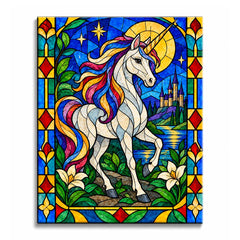 Against a golden moon and deep blue sky, a white unicorn with a rainbow mane stands before a distant castle and lake in a stained glass paint by numbers design with an ornamental floral border.