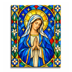 A stained glass Virgin Mary paint by numbers design with a blue robe, joined hands, gold halo, white lilies, and surrounding blue-green glass panels.
