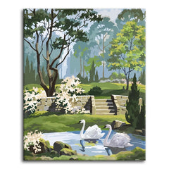 A serene vintage paint by numbers scene of two white swans gliding on a pond in a lush green garden, with old stone steps, tall trees, and flowering shrubs under a soft misty sky.
