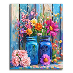 Bright wildflowers and daisies in two blue glass jars against a weathered painted-wood fence with pink carnations at the base, shown as a paint by numbers canvas.
